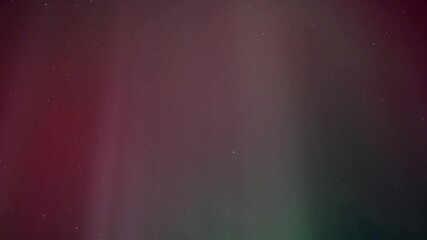 Wall Mural - time lapse of red, green and purple aurora curtains moving in the starry night sky.