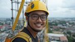 © Business Image - Smiling construction worker with safety harness on urban rooftop