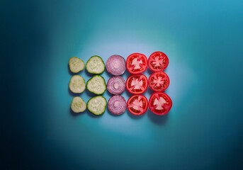 Poster - Sliced cucumbers, tomatoes, and onions arranged in rows on a blue background.