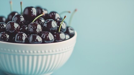 Aufkleber - Fresh ripe black cherries in a white bowl on a blue background copy space : Generative AI