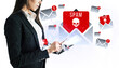 © Who is Danny - Businesswoman using a tablet with spam email icons on white