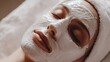 © NOPPHINAN - woman enjoying a relaxing spa facial treatment with a white moisturizing mask applied, promoting skincare and wellness in a calm environment.