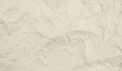 beige wrinkled paper background recycled from paper packaging. the paper is a light beige color.
