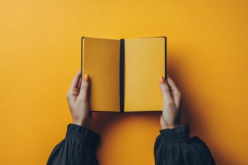 An individual holding a designer notebook with a solid color backdrop, highlighting its sophisticated cover and high-quality paper