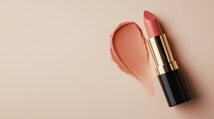 A pink lipstick with a smear of lipstick on a pink background.