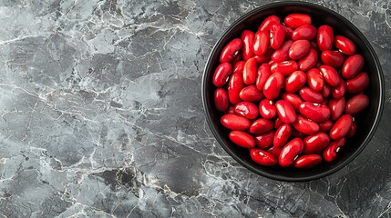 Poster - Red kidney beans in a black bowl on grey stone background Top view Copy space : Generative AI