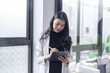 © Charlie's - Beautiful asian doctor Education profession doctor in white uniform gown coat Professional medical doctor with tablet at seminar or hospital wellness center
