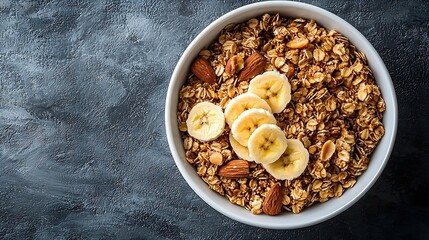 Poster - Healthy breakfast Fresh granola muesli with coconut banana and nuts in a white bowl on grey textile background Top view : Generative AI
