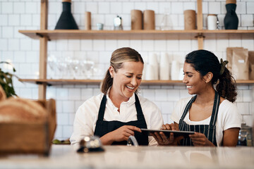 Poster - Business women, cafe and laughing with tablet in small bakery for new recipe or service at retail store. Female people, employees or young waitress with smile on technology for startup at coffee shop