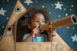 © Анна Мартьянова - black, african american boy look through binoculars from handmade cardboard space rocket in children room , decorated stars and planets.  DIY concept