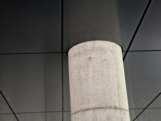 sheet metal ceiling covering made of sheet metal plates. concrete column in the underpass of a modern building