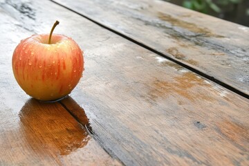 fresh apple resting on a rustic wooden table