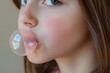 © Gema Vélez - Close-up profile shot of girl blowing a bubble with her chewing gum.