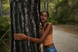 © Westend61 - Teenage girl hugging tree trunk in forest