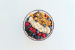 © Westend61 - Healthy yogurt bowl of muesli with fruits and chia seeds over white background