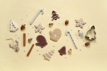 Wall Mural - Tasty Christmas gingerbread cookies and decor on beige background