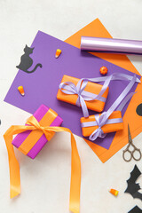 Wall Mural - Halloween decorations with gift boxes, candy corns and wrapping paper on white background