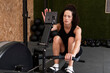 © Westend61 - Woman training on rowing machine in gym