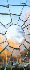 Fragmented glass window with circular hole, soft blurred background