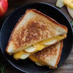 Sticker - Grilled cheese sandwich, sliced apples, black plate, wooden table, crispy bread, melted cheese