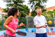 © unai - Team playing pickelball in an outdoor court