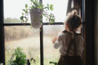 © Halfpoint - Portrait of an adorable little girl sitting on the kitchen counter, looking out of window.