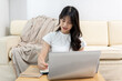 © Kittipong - Asian woman having online meeting on laptop