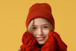 © Pixel-Shot - Cute little boy in winter clothes on yellow background