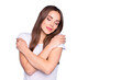 © deagreez - Portrait of cute lady touching her shoulders closing eyes wearing white t-shirt isolated over blue background