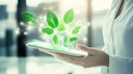 A hand holds a tablet displaying glowing green leaves and a house, symbolizing eco-friendly technology and sustainability.