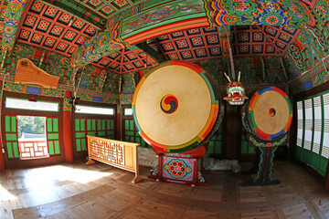 Wall Mural - Mungyeong-si, Gyeongsangbuk-do, Korea - October 18, 2014: Wide angle view of the wooden drums with colorful dancheong of the ceiling in Gimlyongsa Temple