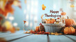 © Camalia MN - Pumpkins, autumn leaves, with the word 'Happy Thanksgiving'. Thanksgiving day background.