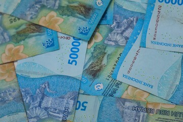 Background of a pile of banknotes with a value of Rp. 50000, with a close up view.