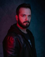 Brazilian Man in black hooded jacket with soft studio lighting highlighting with facial contours