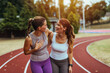 © Dragana Gordic - Two Friends Laughing Together During Outdoor Exercise Session