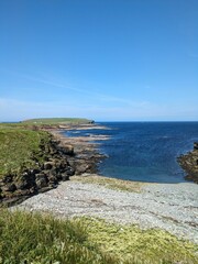 Rocky coastline with clear blue water and bright sky