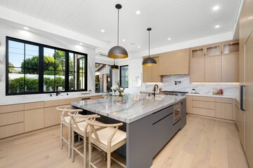 Modern kitchen with marble countertops and wooden cabinets.