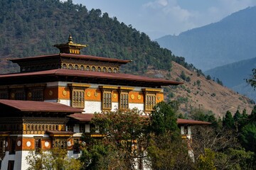 Traditional Bhutanese architecture with mountain backdrop.