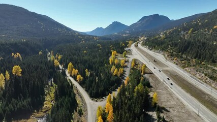 Wall Mural - Drone flying over dense forest during autumn, along Coquihalla Highway in British Columbia, Canada