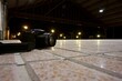 © Wirestock - Camera resting on the ground and illuminated by a bright floor. DSLR in the foreground