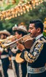 © jambulart - Man playing trumpet in mariachi outfit.