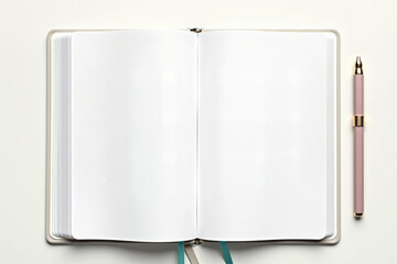 Open notebook with blank pages and pen on white desk