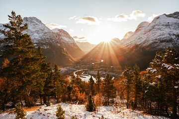 Sunndal industrial town sunset in the autumn / winter with snow cowered mountains and sun lens flare art wall art landscape