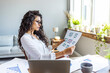 © Dragana Gordic - Focused Businesswoman Analyzing Data In Bright Office Space