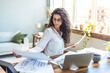 © Dragana Gordic - Confident Woman Analyzing Documents at Home Office Desk