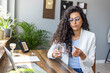 © Dragana Gordic - Professional Woman Taking Medication at Modern Office Desk