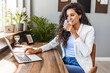 © Dragana Gordic - Young Woman Working Remotely with Laptop and Drinking Water