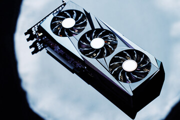 Fototapete - Close-up of high-performance graphics card with three cooling fans on dark background. Modern video card for gaming and advanced computing