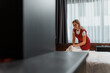 © DusanJelicic - Portrait of a charming hotel maid putting fresh clean folded towels on the bed.