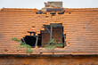 hole in the tiles in the roof of an old abandoned house